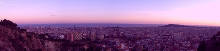 Barcelona skyline at golden hour with the Sagrada Família and the Mediterranean